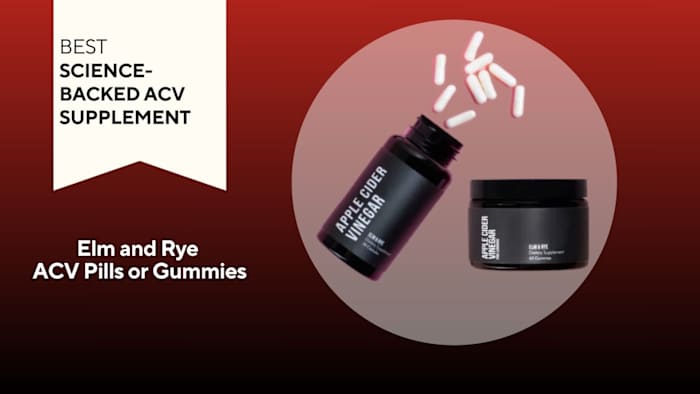 Black pill bottle with white capsules spilling out and a small black containter against a red background